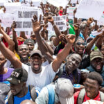 day-in-photos:-protests-in-gambia,-detention-of-illegal-immigrant,-and-peace-talks-between-ukraine-and-russia