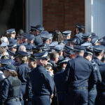sea-of-blue-as-fallen-police-officer-farewelled,-manhunt-for-alleged-killer-intensifies