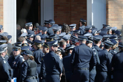 sea-of-blue-as-fallen-police-officer-farewelled,-manhunt-for-alleged-killer-intensifies