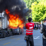 g7-protesters-smash-windows,-set-tesla-on-fire-in-geneva