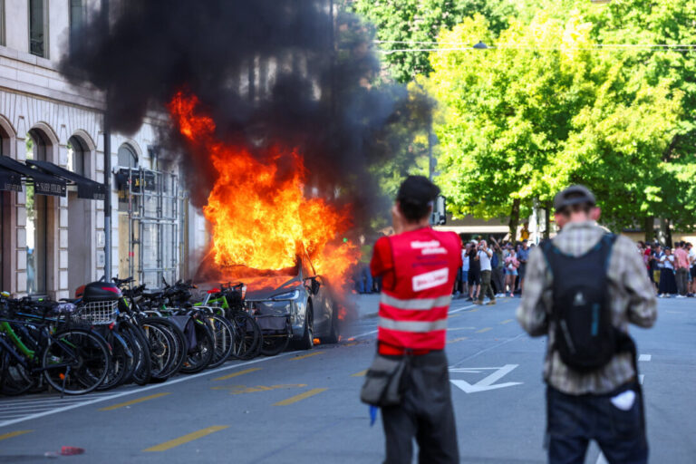 g7-protesters-smash-windows,-set-tesla-on-fire-in-geneva