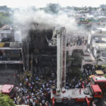 day-in-photos:-india-fire-disaster,-south-africa-protest-rally,-and-ancient-mural-uncovered