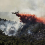 day-in-photos:-massive-wildfire-in-france,-military-drone-exercise,-and-protest-in-india